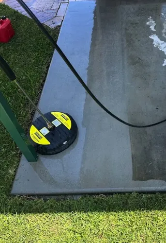 Close-up of a Kärcher surface cleaner on a concrete slab